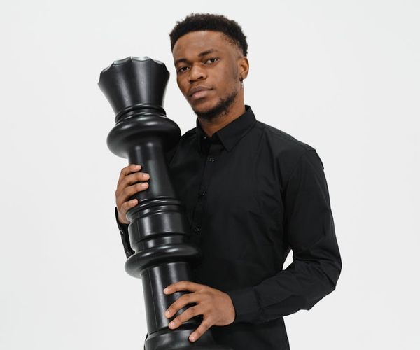 Man holding a difficult balance pose, showing focus and physical control.